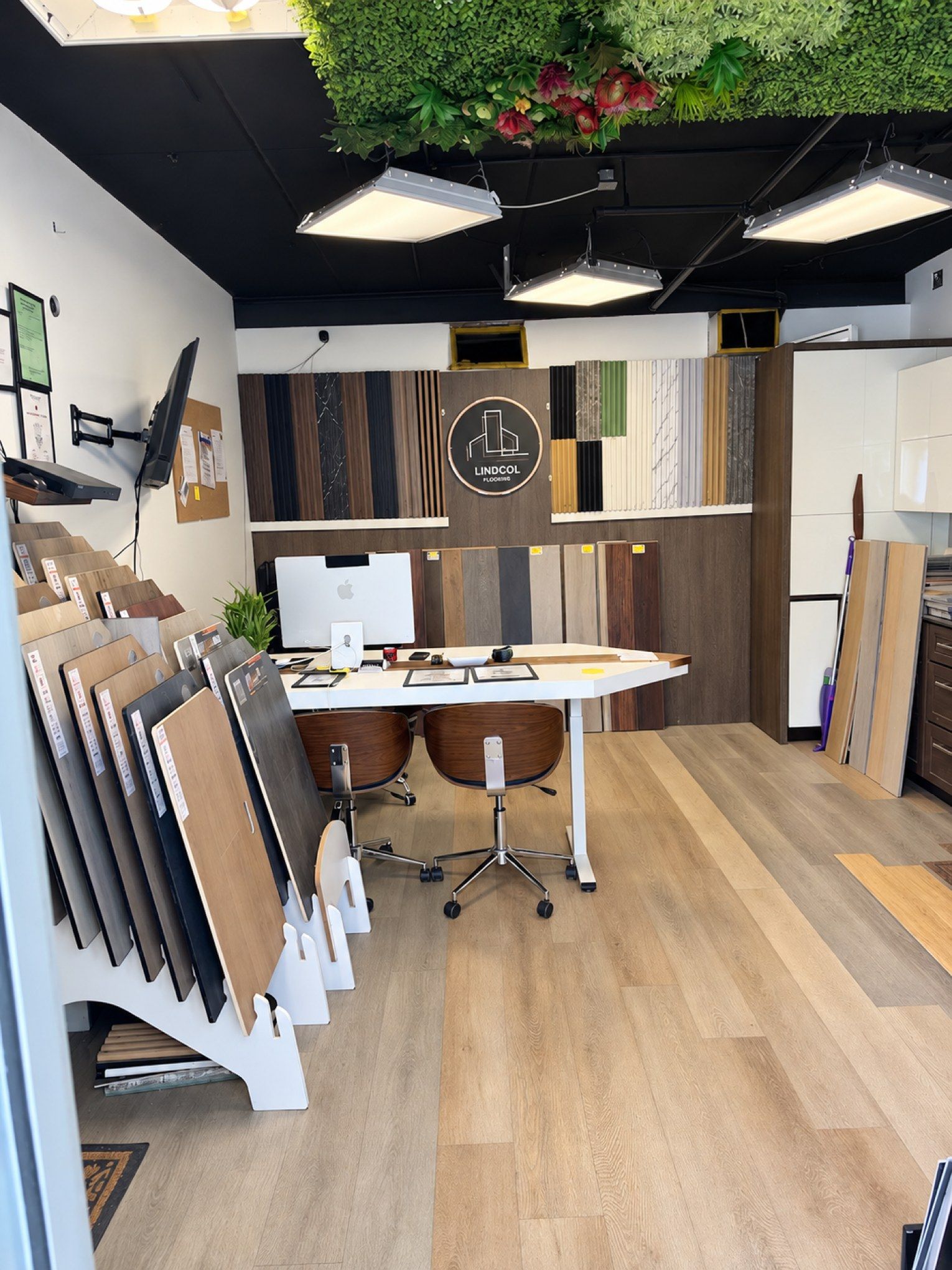Inside the Lindcol Wood Floors showroom in Medley, with sample boards, wall panels and the Lindcol sign